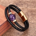 Detailed macro of double-layered black leather bracelet with purple stone and gold clasp - Gold-Purple Stone
