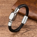 Close-up of black braided leather bracelet with silver metal charms on a dark wood table - Silver Metal Cube / Silver