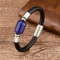 Detailed macro view of black braided leather bracelet with blue stone and steel clasp - Lapis Lazuli / Gold
