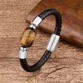 Macro detail of men's black braided leather bracelet with stainless steel tiger eye stone - Rectangular Tiger Eye / Silver