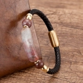 Close-up of woven black leather bracelet with red stone bead and gold magnetic clasp - Gold Red Jasper