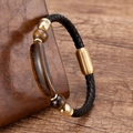 Detailed macro view of woven black leather bracelet with tiger eye stones and gold buckle - Gold-Tiger's Eye
