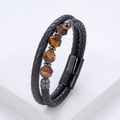Detailed macro view of black braided leather bracelet featuring tiger eye stone beads - Black (Yellow Tiger Eye)