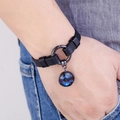 Detailed close-up of a black leather star constellation bracelet worn by a model - Sagittarius (Gold)