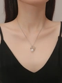 Close-up of elegant silver reindeer antler necklace with a white pearl on a female model - Silver