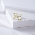Golden geometric U-shaped open ring with double-layered pavé crystals on a white pedestal - Gold