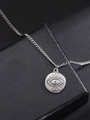 Detail of silver evil eye pendant on a chain over a black textured jewelry box - Sun Radiance Style / Silver