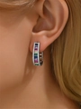 Close-up of C-shaped earring with multicolor rectangular gemstones and pavé crystals - Silver