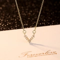 Fashionable gold V-pendant necklace with baguette-cut zircons on decorative card - V-shape Style / Gold