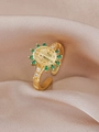 Detail of vintage gold ring with Virgin Mary relief and green faceted emerald-like stones - Green