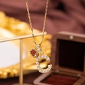 Gold letter C necklace with micro-paved zircons and red apple pendant detail - Letter C
