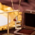 Gold letter E pendant necklace with clear crystals and a red heart accent - Letter E