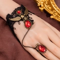 Gothic lace slave bracelet featuring bronze skull charms and a red teardrop gemstone - Slave Bracelet With Ring Skull Wings Red Rhinestone Style