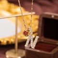 Gold-plated letter N pendant necklace with white zircons and a small red apple charm - Letter N