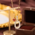 Gold pendant necklace featuring a red pomegranate and clear zircon pave oval link - Letter O