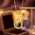 Golden letter Q pendant necklace with sparkling cubic zirconia in a circular frame - Letter Q