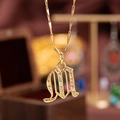 Gold plated letter M pendant necklace with shimmering cubic zirconia on twisted chain - M