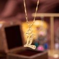 Golden pendant necklace with copper-inlaid zircon in the shape of letter L - L