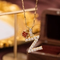 Luxury gold necklace featuring a letter Z pendant with white crystals and red crown - Letter Z