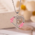 Collana a cuore argento con fiori in smalto rosa e ciondolo lettera F in cristallo - Lettera F / Argento