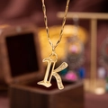 Polished gold initial K necklace pendant with sparkling cubic zirconia inlay and fine chain - Letter K