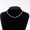 Detailed close-up of rainbow bead necklace featuring a gold heart pendant with letter B - Letter B