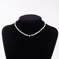 Rainbow seed bead necklace with gold heart pendant featuring a letter J charm - Letter J