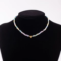 Colorful macaron bead necklace with a golden heart pendant featuring engraved letter O - Letter O
