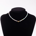 Rainbow beaded necklace with gold heart charm engraved with the letter R on a black bust - Letter R