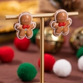 Orecchini a forma di pan di zenzero con dettagli festivi su supporto dorato - Omino di pan di zenzero