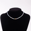 Rainbow macaron bead necklace with a golden heart pendant featuring engraved letter U - Letter U