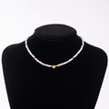 Rainbow macaron beaded necklace with a golden heart pendant featuring engraved letter X - Letter X