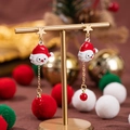 Orecchini a goccia Babbo Natale con perni a stella dorati e catena di perline rosse - Testa di Babbo Natale con catena a stella
