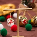 Orecchini a doppia campana di Natale in smalto rosso e strass su ganci dorati - Fiocco Campanello Stile 2