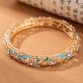 Vintage gold-plated hollow bangle with blue enamel flowers and sparkling rhinestones - Sunflower - Blue
