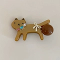 Close-up of brown acetate cat hair clip with colorful rhinestones and white bow detail - Brown