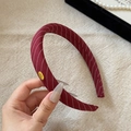 Detail of burgundy striped sponge headband with gold Hand Made metal tag accessory - Red
