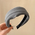 Detailed view of dark grey padded velvet headband with non-slip lining and thick sponge design - Gray