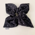 Detail of oversized denim hair scrunchie with white heart pattern and stitched logo tag - Black Denim Scarf Scrunchie