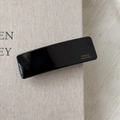 Detail of black rectangular barrette with gold France Handmade lettering on linen - Black
