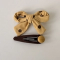 Close-up of yellow polka dot bow hair clip and brown hairpin with bead decoration - Bowknot Hair Clips Pair