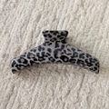 Close-up of a large grey leopard print hair claw clip on a white textured fabric background - Gray Leopard-Hanger Style A