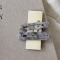 Detailed macro view of purple acetate hair clips set with elegant marble texture and waves - Grey Purple