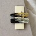 Close-up of tortoise shell and gray marble acetate hair clips on beige linen background - Yellow-Green