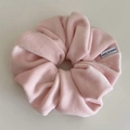 Detail view of pink velvet oversized scrunchie with soft texture and Made in Korea tag - Pink