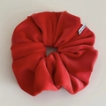 Detail shot of large red velvet scrunchie with soft texture and Made in Korea label - Red