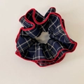 Close-up of blue plaid scrunchie with red scalloped edges and textured fabric detail - Navy Blue Plaid with Red Edge