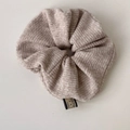 Beige knitted scrunchie with soft texture and brand label for autumn winter hairstyles - Oatmeal