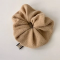 Detail of khaki knitted scrunchie texture with professional brand fabric label - Apricot