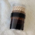 Detailed view of elastic wavy hair ties in gradient beige to coffee shades in a plastic tube - Braided Coffee Tones